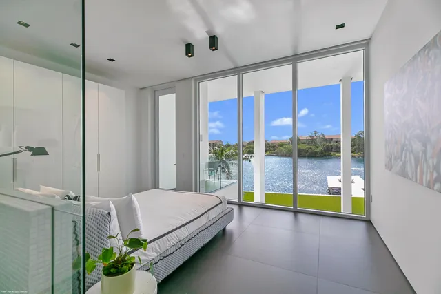 a view of swimming pool with a yard and palm trees