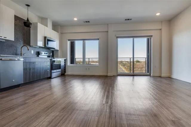 an open kitchen with sink and cabinets