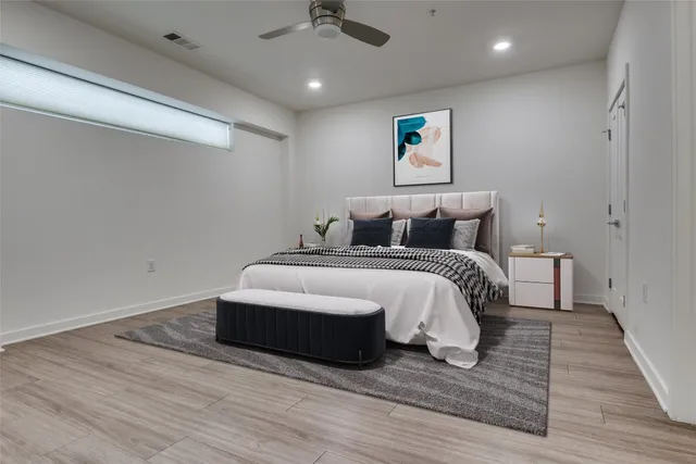 a bedroom with a bed and wooden floor