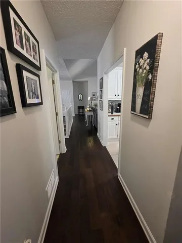 a view of hallway with stairs and wooden floor