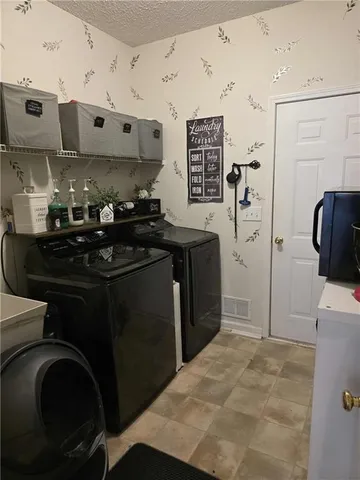 a kitchen with stainless steel appliances granite countertop a stove a refrigerator and a sink