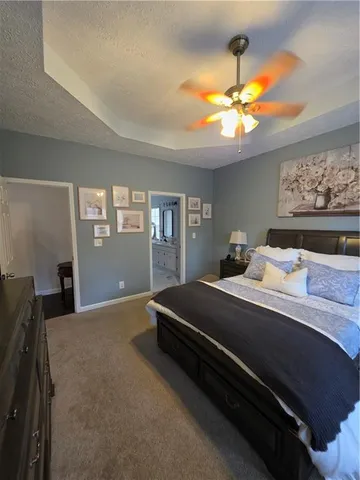 a bed room with a bed mirror and a chandelier