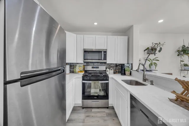 a kitchen with a sink stove and microwave