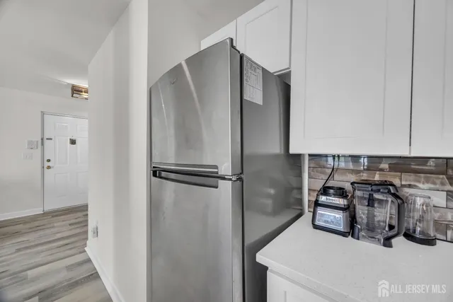 a kitchen with a refrigerator and a sink
