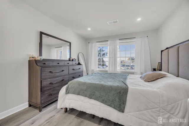 a bedroom with a bed and a dresser