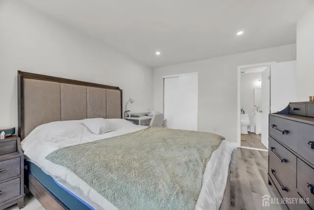 a bedroom with a bed and a dresser