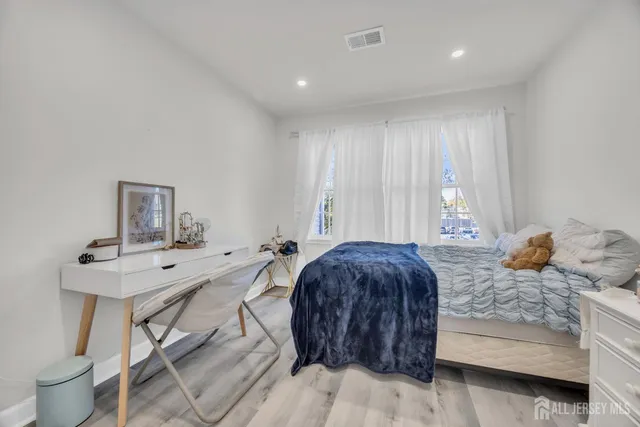 a bedroom with a bed and a table