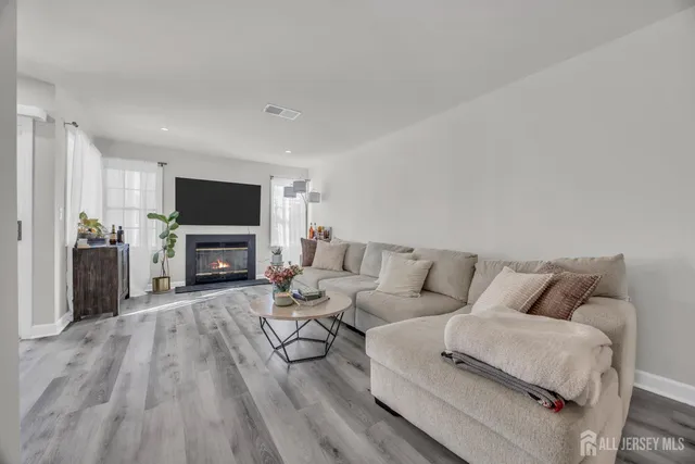 a living room with furniture a fireplace and a television