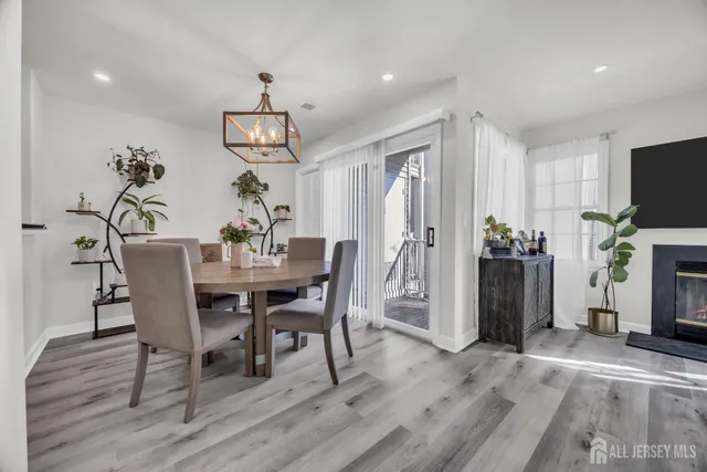 a dining room with furniture a chandelier and wooden floor