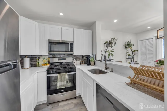 a kitchen with a sink stove and microwave