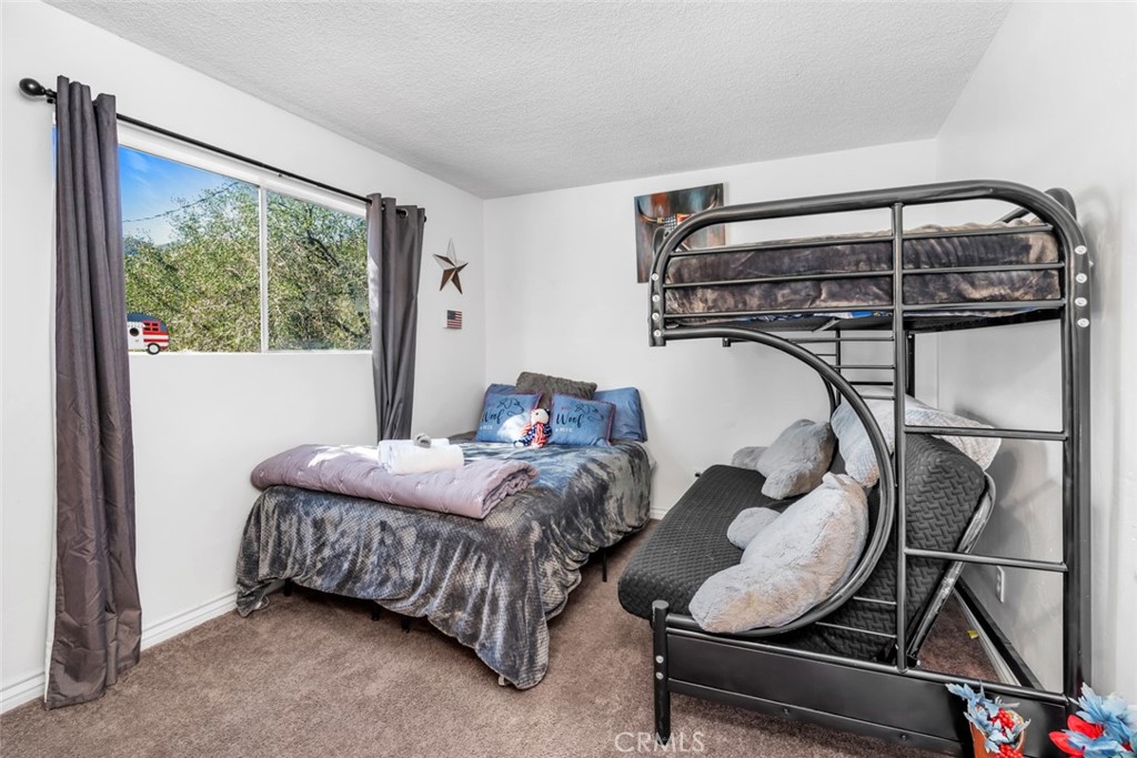 245 Mountain Shadow Road Wofford Heights, CA 93285 - Photo 14 of 72 a bedroom with bed and a window