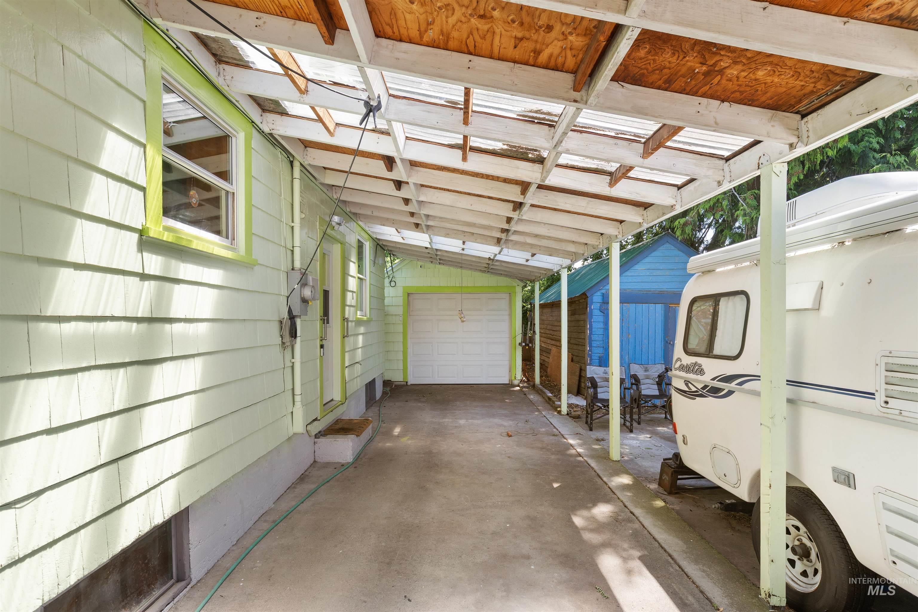 924 N Street Lewiston, ID 83501 - Photo 38 of 46 Covered concrete driveway with clear panel roofing and wood beam support structure