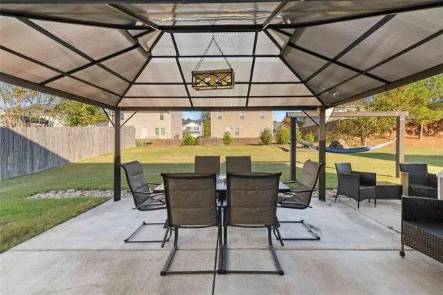 a view of backyard with barbeque grill and plants
