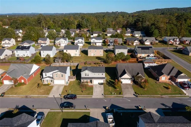 an aerial view of residential houses with outdoor space