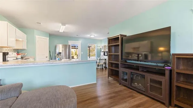 a kitchen with stainless steel appliances kitchen island granite countertop a stove and a refrigerator