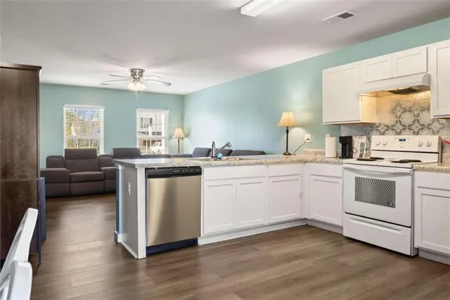 a kitchen with a white cabinets and white appliances
