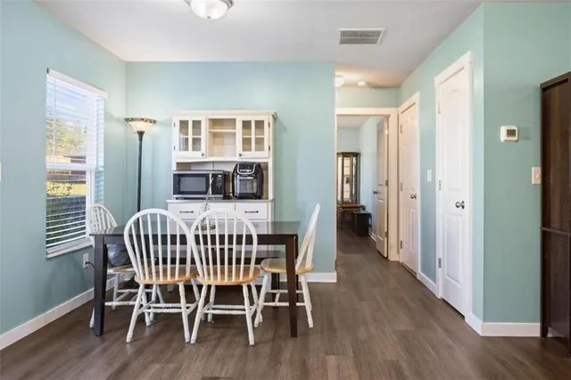 a dining room with furniture and wooden floor
