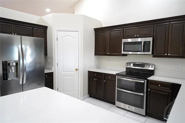 a kitchen with a refrigerator stove and microwave