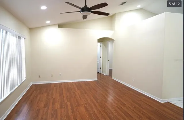 wooden floor in an empty room with a window