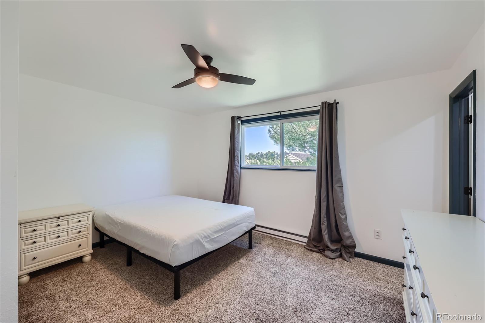 2452 Shetland Trail Elizabeth, CO 80107 - Photo 12 of 42 a bedroom with a bed and a window