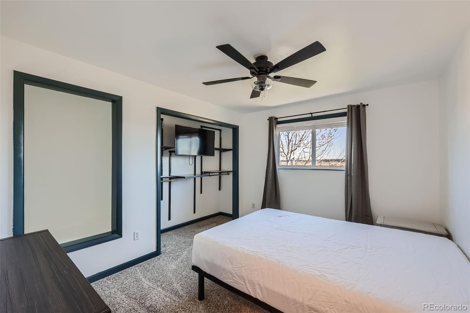 2452 Shetland Trail Elizabeth, CO 80107 - Photo 19 of 42 a bedroom with a large bed and a window