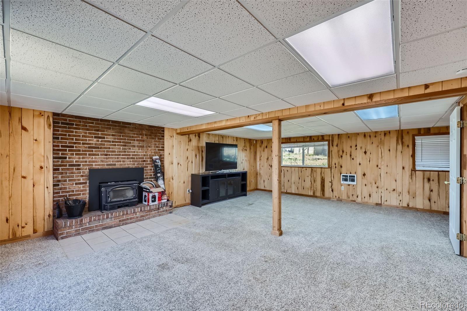 2452 Shetland Trail Elizabeth, CO 80107 - Photo 22 of 42 an empty room with furniture and a fireplace