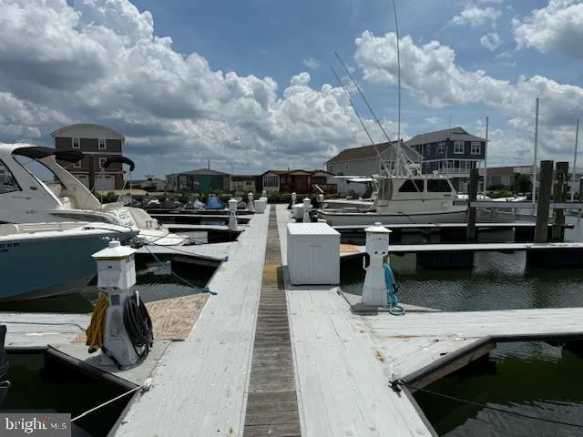 a roof deck with table and chairs