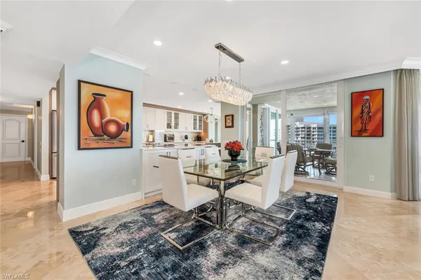 a living room with furniture a wooden floor and chandelier