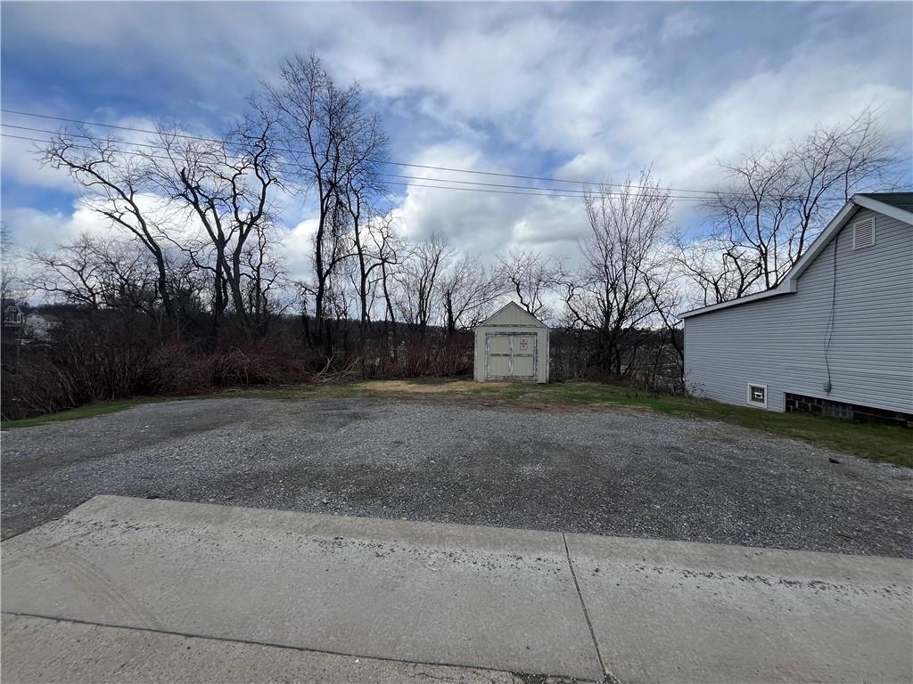 1360 Center Street McKees Rocks, PA 15136 - Photo 3 of 18 a view of a backyard with large trees