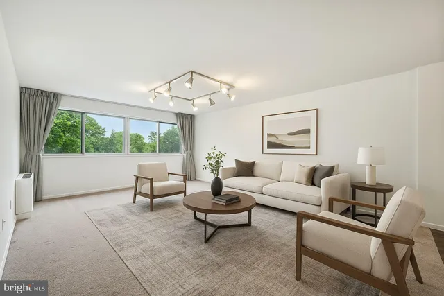 a living room with furniture and a large window