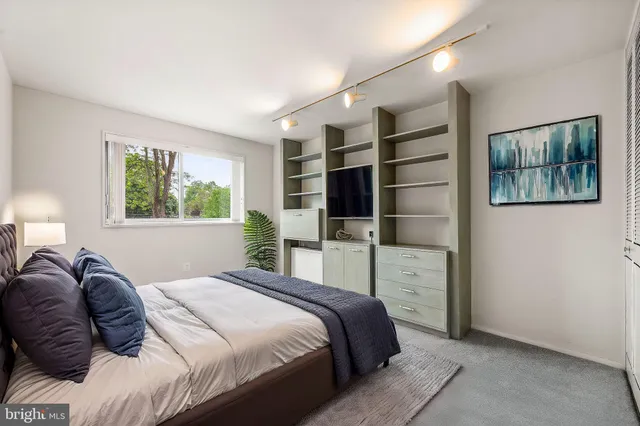 a bedroom with a large bed and a window