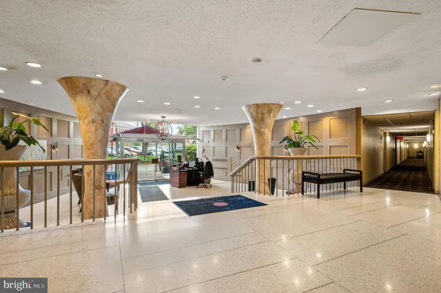 a lobby with furniture and lots of large windows