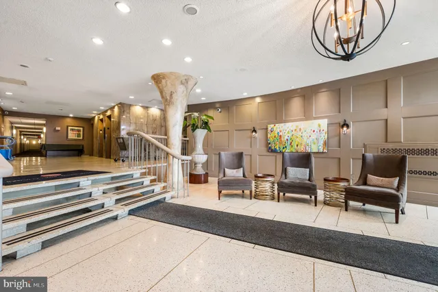 a lobby with furniture and stairs