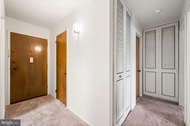 a view of a hallway with closet area
