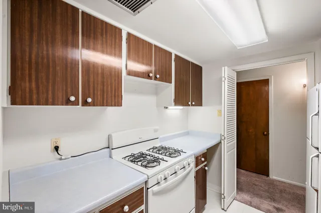 a kitchen with granite countertop a stove and a refrigerator