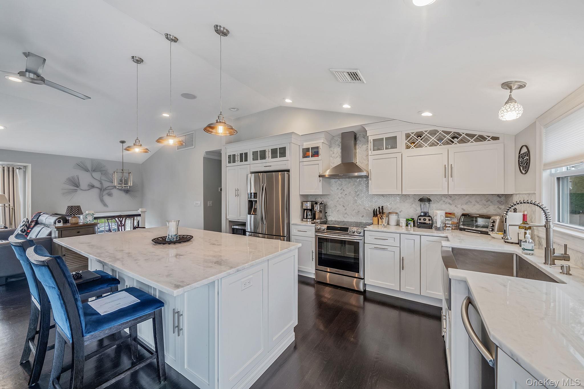 110 Stephen Road Bayport, NY 11705 - Photo 20 of 39 a kitchen with a stove a refrigerator and a dining table