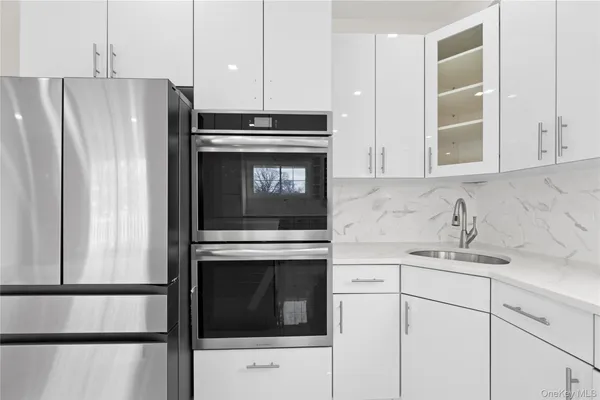 a kitchen with cabinets stainless steel appliances and counter space