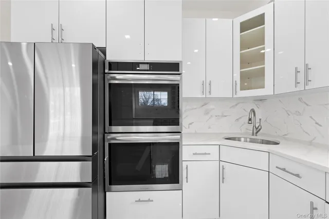 a kitchen with cabinets stainless steel appliances and counter space