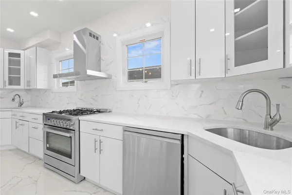 a kitchen with stainless steel appliances granite countertop a sink stove and cabinets