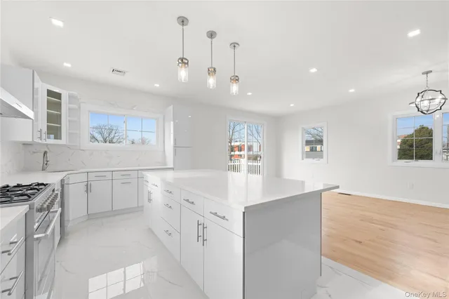 a kitchen with granite countertop a sink and a stove top oven