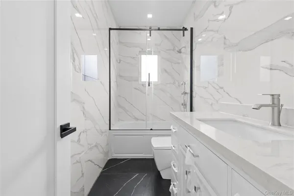 a bathroom with a shower sink and mirror