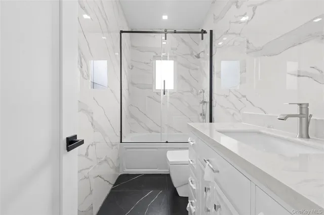 a bathroom with a shower sink and mirror