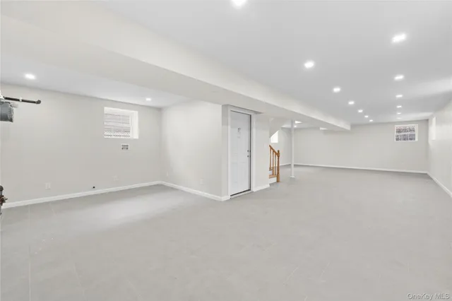 an empty room with a empty space and windows