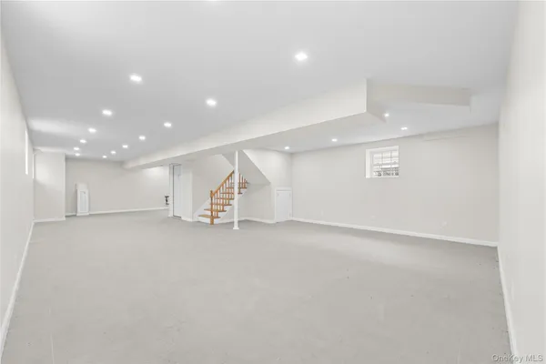 an empty room with a kitchen and entryway