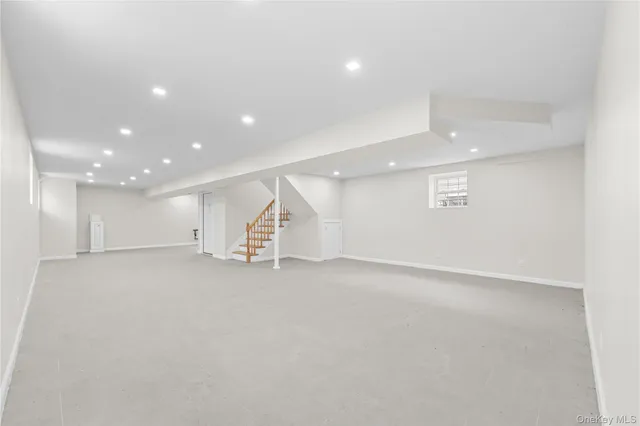 an empty room with a kitchen and entryway