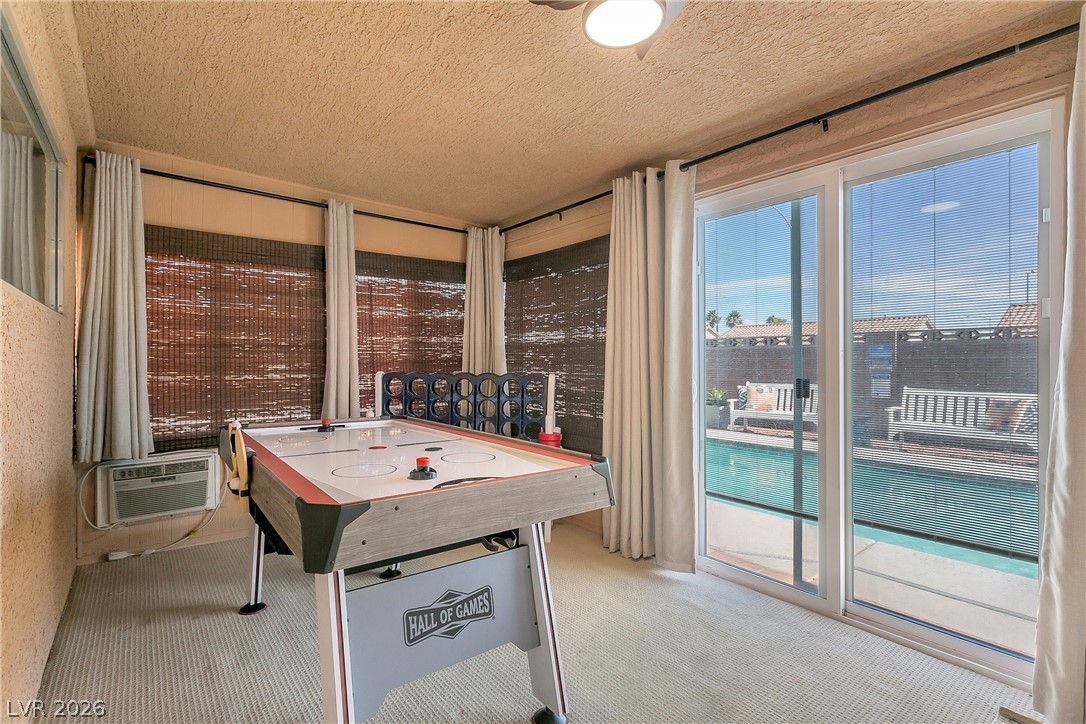 101 Beaver Ridge Avenue North Las Vegas, NV 89031 - Photo 27 of 42 A vibrant game room offers direct access to a private outdoor pool through large glass sliding doors.
