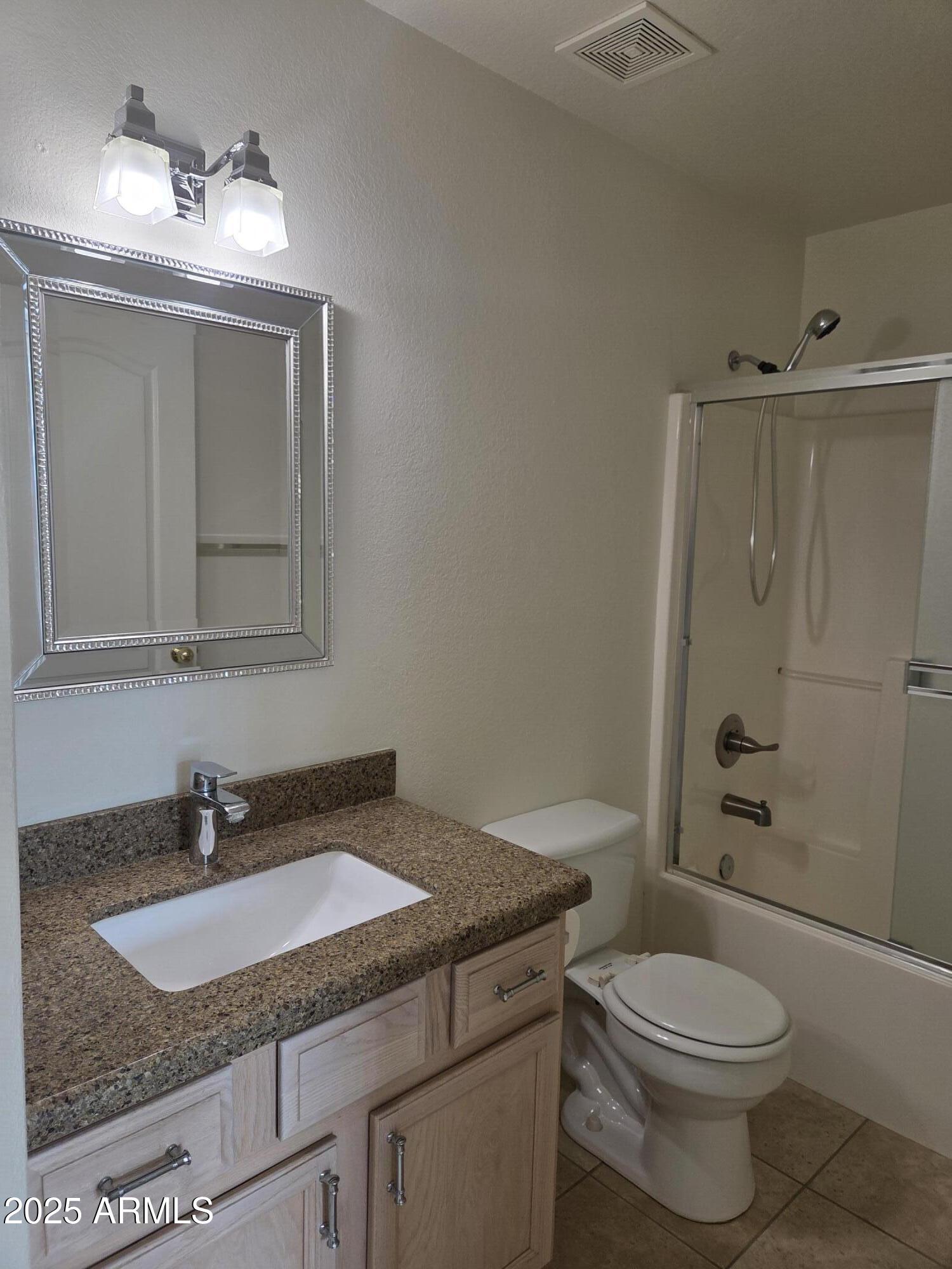 9151 West Greenway Road, Unit 182 Peoria, AZ 85381 - Photo 10 of 19 a bathroom with a granite countertop sink toilet and shower