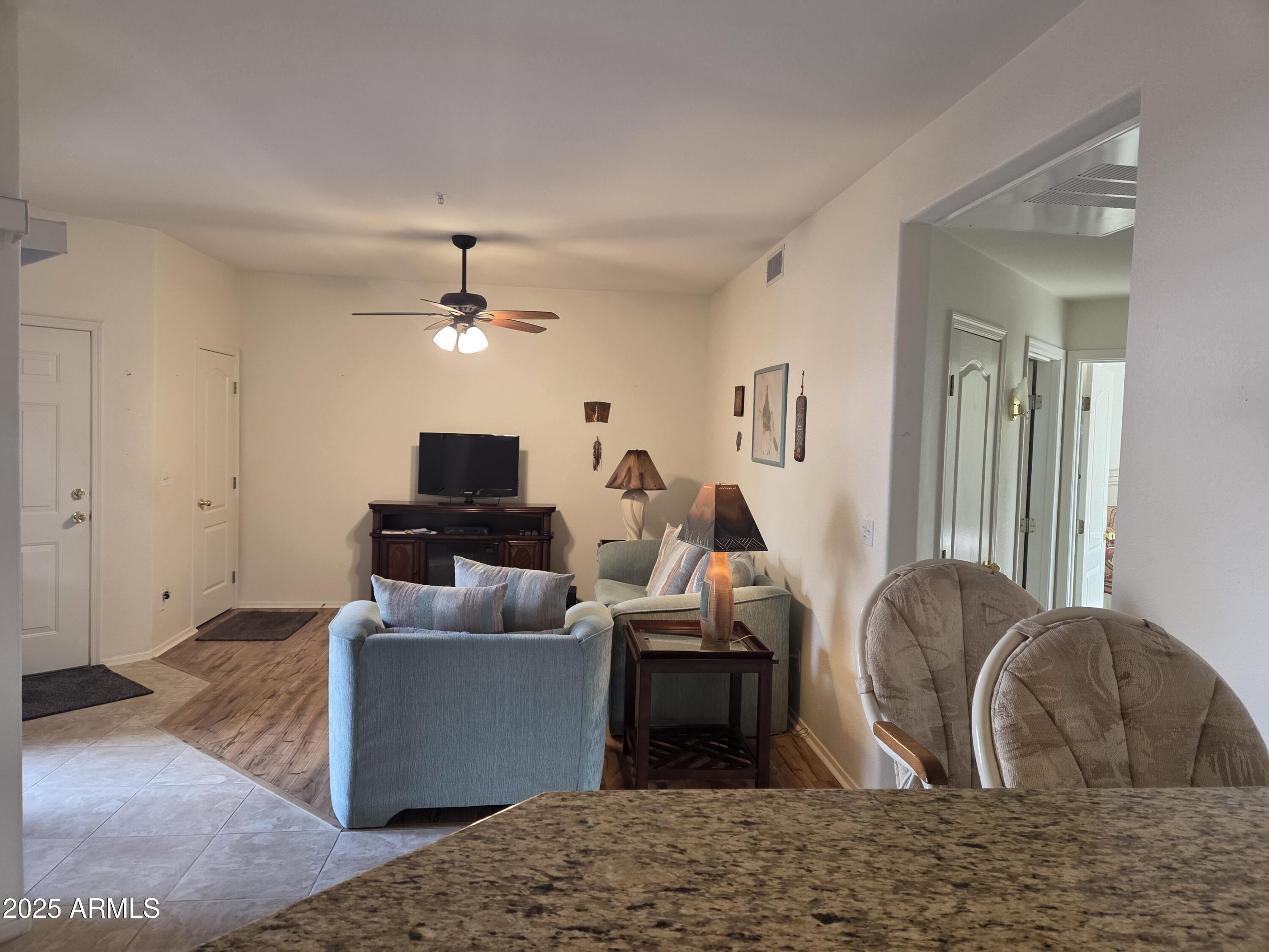 9151 West Greenway Road, Unit 182 Peoria, AZ 85381 - Photo 11 of 19 a living room with furniture and a flat screen tv