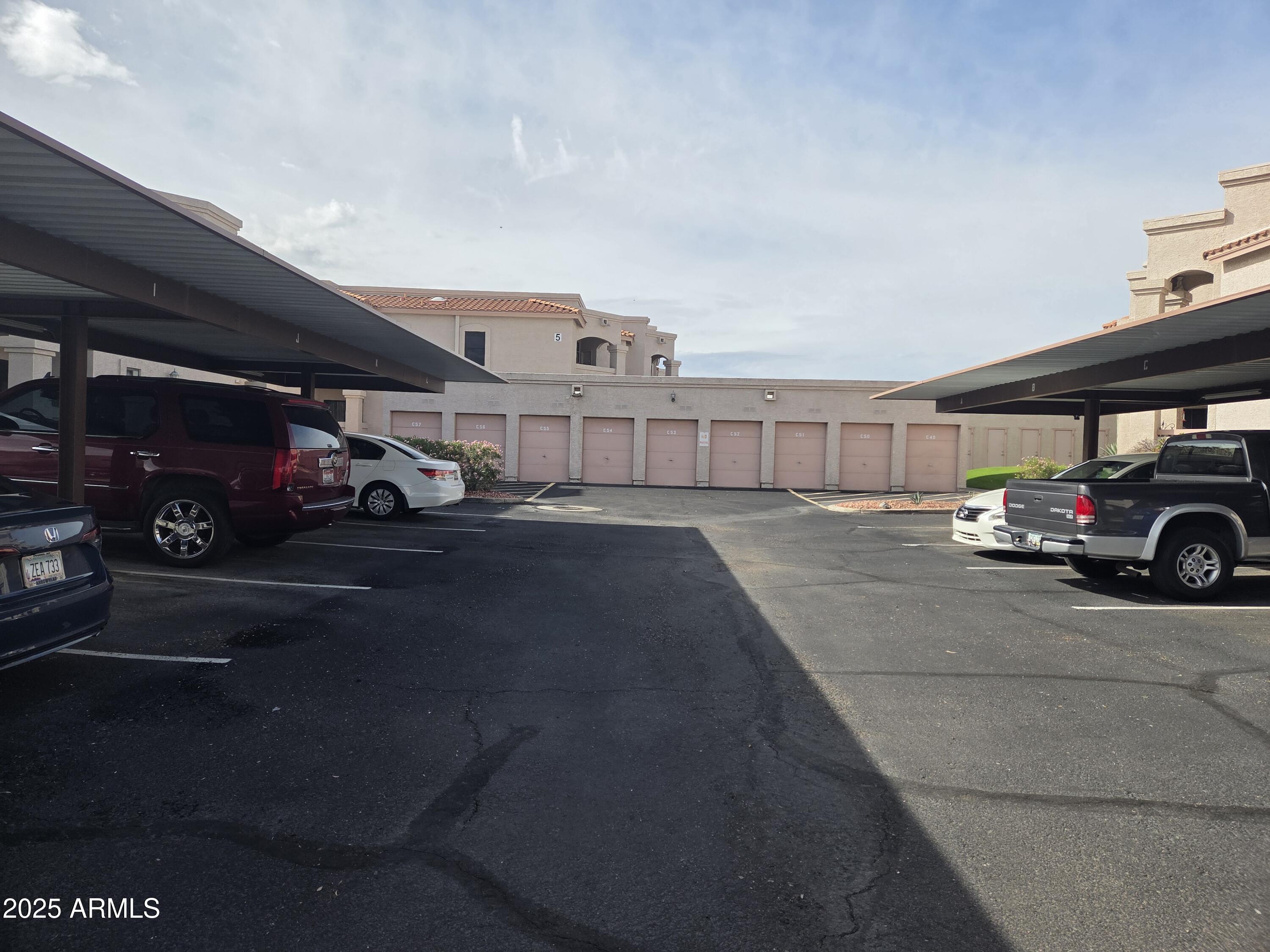 9151 West Greenway Road, Unit 182 Peoria, AZ 85381 - Photo 16 of 19 a view of street with parked cars