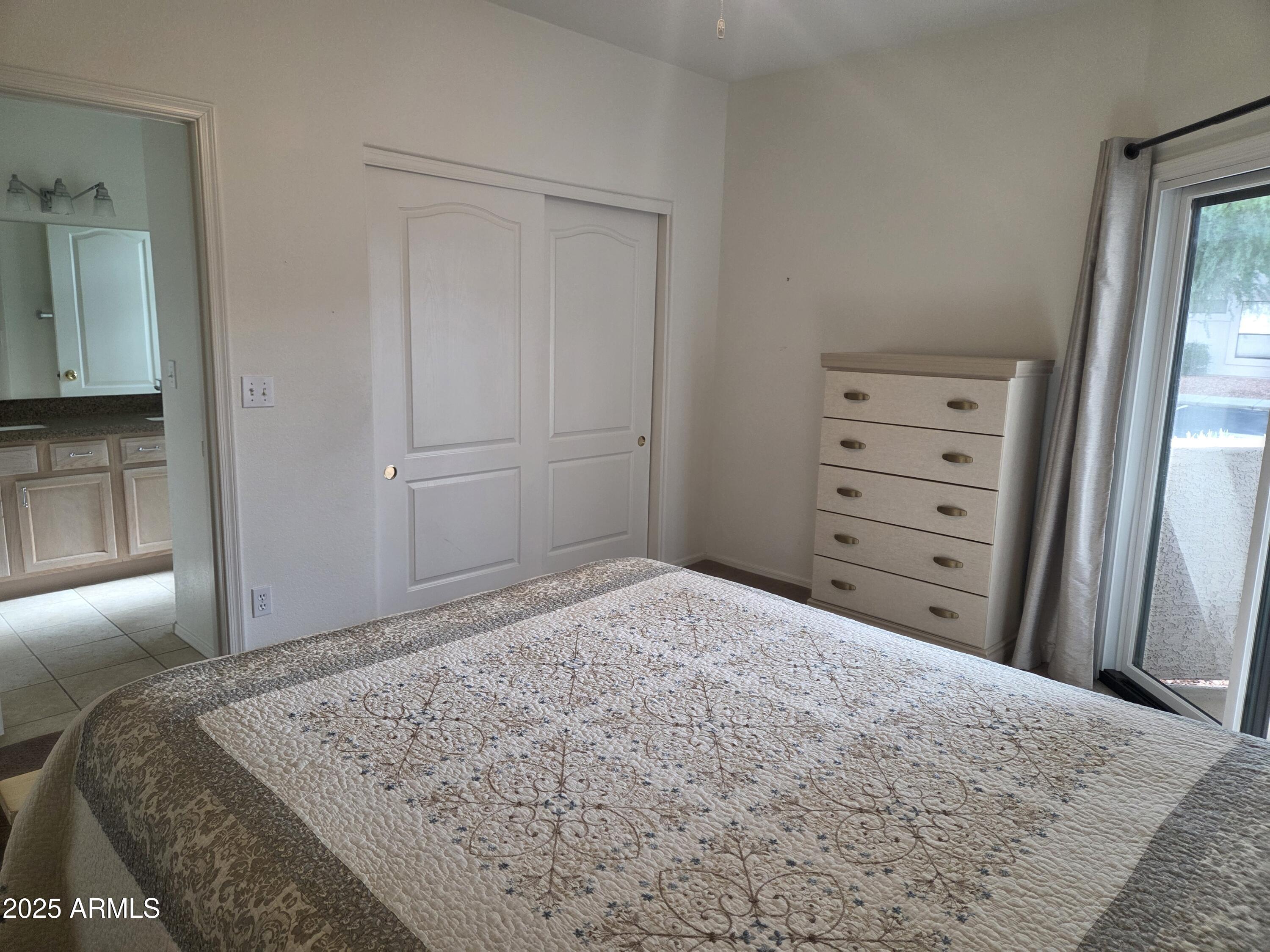 9151 West Greenway Road, Unit 182 Peoria, AZ 85381 - Photo 6 of 19 a bedroom with a bed and a mirror